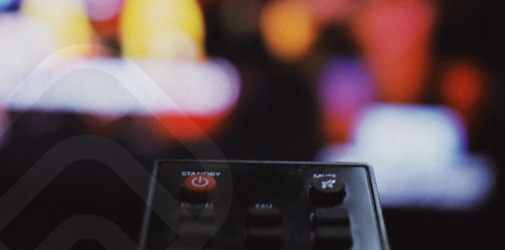 tv remote infront of blurry tv screen
